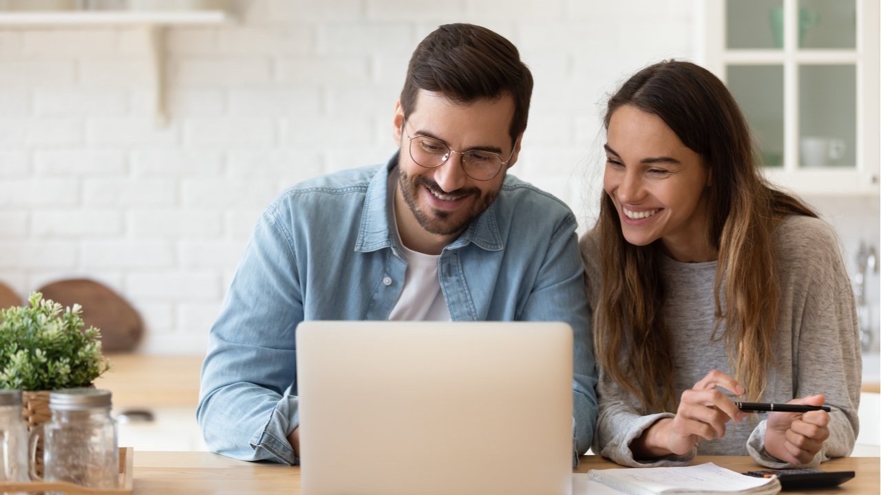 Happy young couple reading acceptance letter for specialist finance